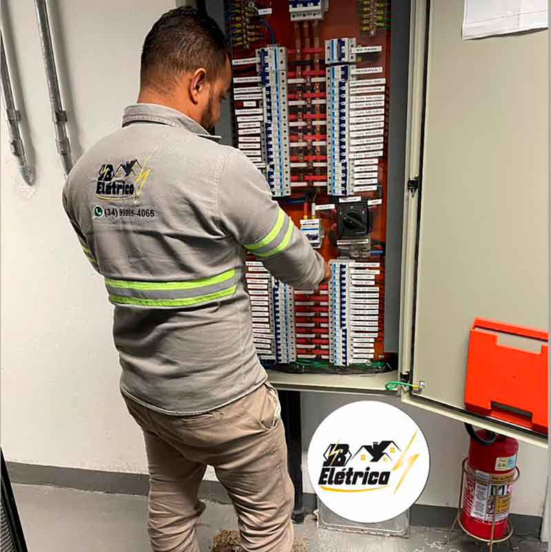 Imagem de um eletricista fazendo manutenção num quadro de energia em Uberlândia